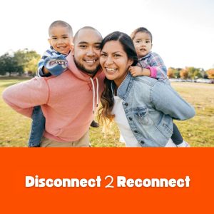 2 Parents and 2 children smiling outside